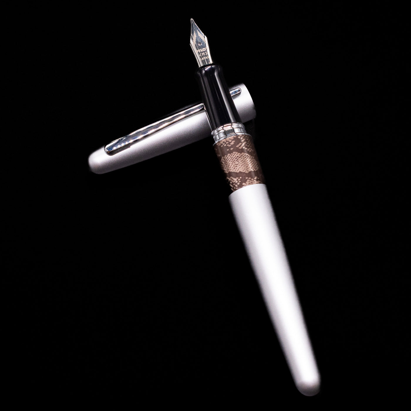 Pilot Metropolitan Fountain Pen - Python laying on top of its cap in a crossed position showing full view of the entire uncapped pen.