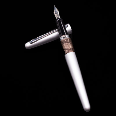 Pilot Metropolitan Fountain Pen - Python laying on top of its cap in a crossed position showing full view of the entire uncapped pen.
