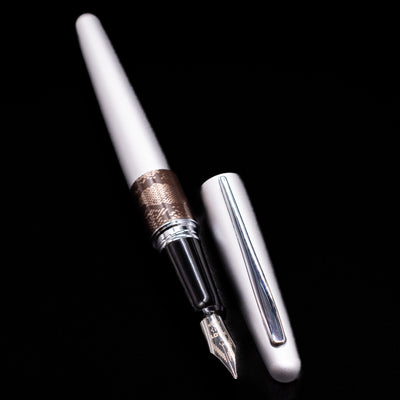 A full view of the Pilot Metropolitan Fountain Pen - Python uncapped, with its cap laying next to the pen. 