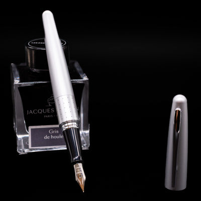 Pilot Metropolitan Fountain Pen - Silver with Dots leaning on an ink bottle uncapped showcasing the detailing on the nib.