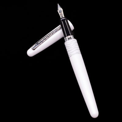 Pilot Metropolitan Fountain Pen - White Tiger laying on top of its cap in a crossed position showing full view of the entire uncapped pen.
