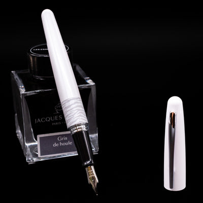 Pilot Metropolitan Fountain Pen - White Tiger leaning on an ink bottle uncapped showcasing the detailing on the nib.