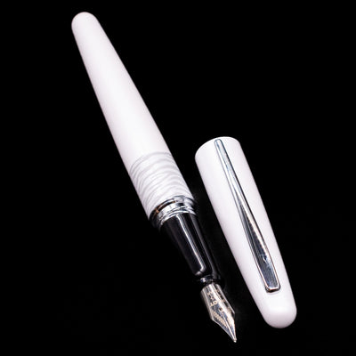 A full view of the Pilot Metropolitan Fountain Pen - White Tiger uncapped, with its cap laying next to the pen. 