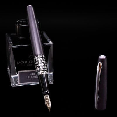 Pilot Metropolitan MR Retro Pop Fountain Pen - Gray leaning on an ink bottle uncapped showcasing the detailing on the nib.