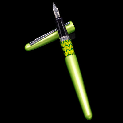 Pilot Metropolitan MR Retro Pop Fountain Pen - Green laying on top of its cap in a crossed position showing full view of the entire uncapped pen.
