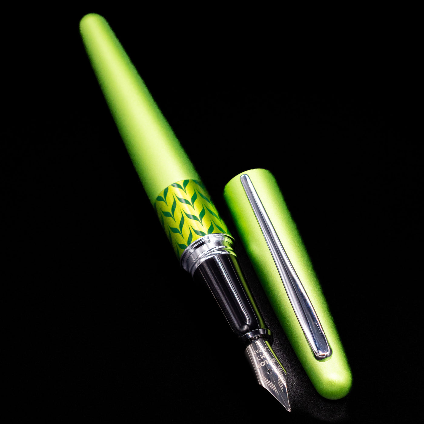 A full view of the Pilot Metropolitan MR Retro Pop Fountain Pen - Green uncapped, with its cap laying next to the pen. 
