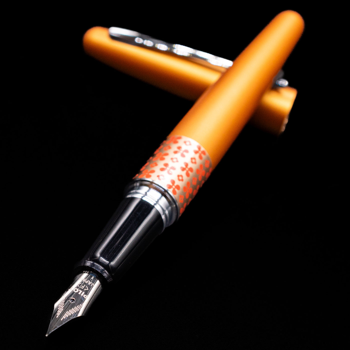 Pilot Metropolitan MR Retro Pop Fountain Pen - Orange laying across its own cap, crossed, with a focus on the nib.