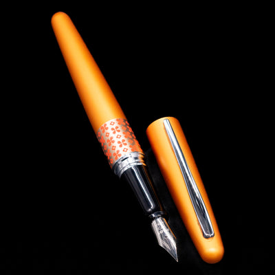 A full view of the Pilot Metropolitan MR Retro Pop Fountain Pen - Orange uncapped, with its cap laying next to the pen.