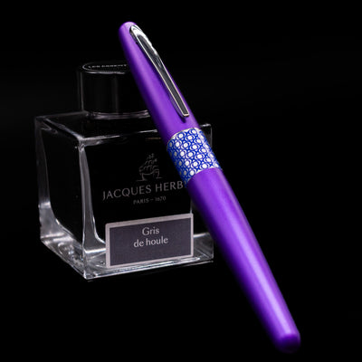 Pilot Metropolitan MR Retro Pop Fountain Pen - Purple capped, leaning against an ink bottle. 
