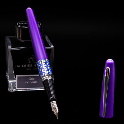 Pilot Metropolitan MR Retro Pop Fountain Pen - Purple leaning on an ink bottle uncapped showcasing the detailing on the nib.