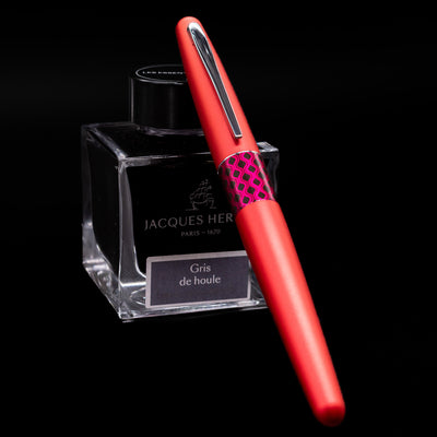 Pilot Metropolitan MR Retro Pop Fountain Pen - Red capped, leaning against an ink bottle. 