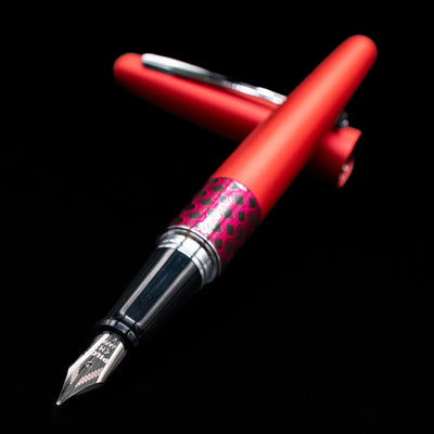 Pilot Metropolitan MR Retro Pop Fountain Pen - Red laying across its own cap, crossed, with a focus on the nib.