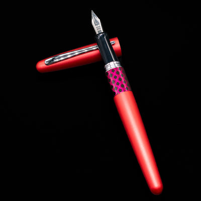 Pilot Metropolitan MR Retro Pop Fountain Pen - Red laying on top of its cap in a crossed position showing full view of the entire uncapped pen.