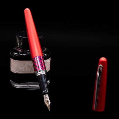 Pilot Metropolitan MR Retro Pop Fountain Pen - Red leaning on an ink bottle uncapped showcasing the detailing on the nib.