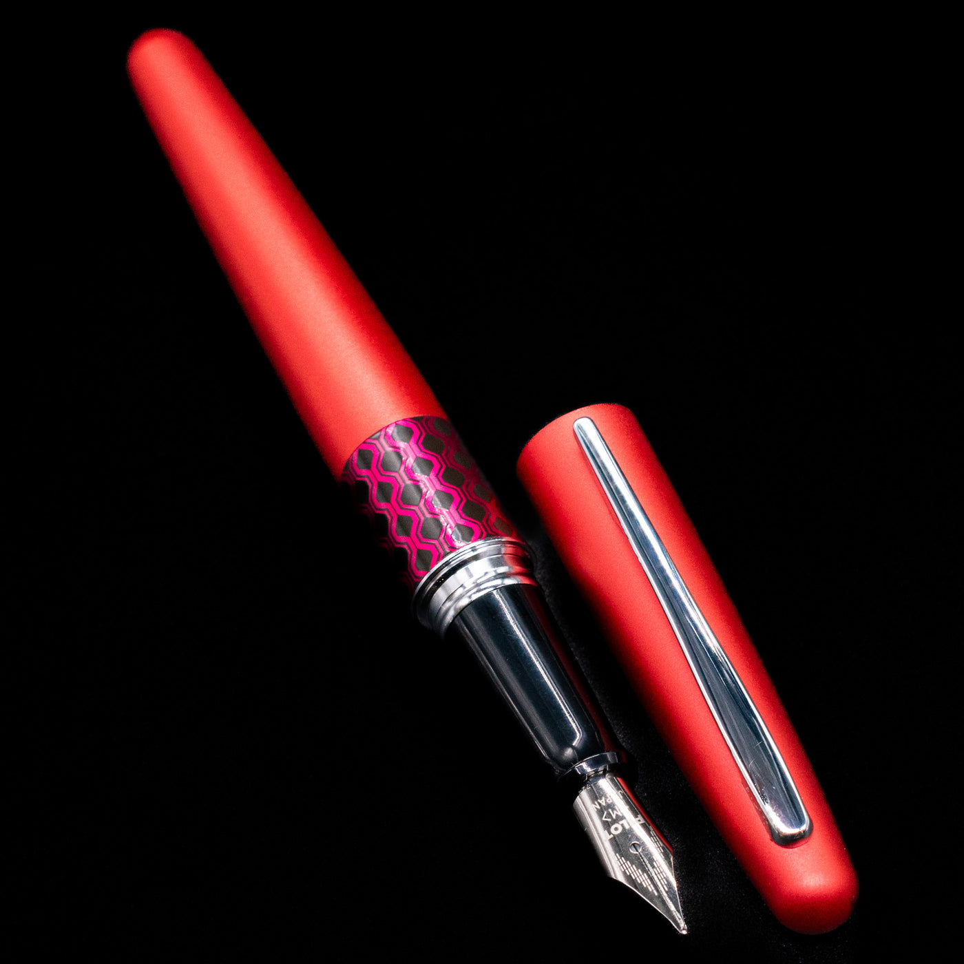 A full view of the Pilot Metropolitan MR Retro Pop Fountain Pen - Red uncapped, with its cap laying next to the pen. 