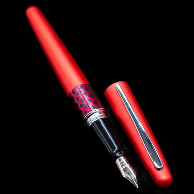 A full view of the Pilot Metropolitan MR Retro Pop Fountain Pen - Red uncapped, with its cap laying next to the pen. 