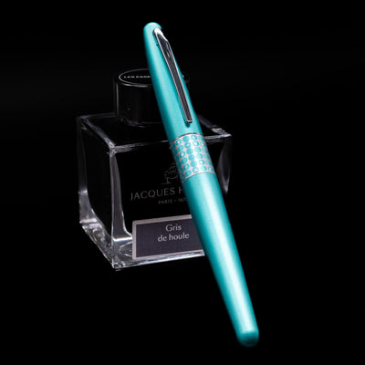 Pilot Metropolitan MR Retro Pop Fountain Pen - Turquoise capped, leaning against an ink bottle. 