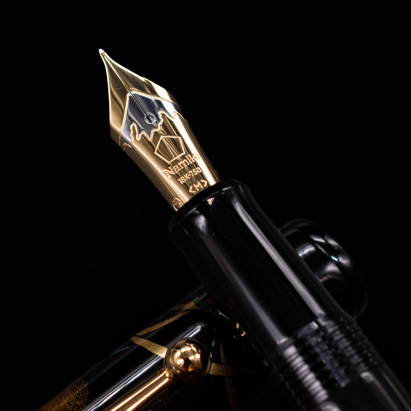 A macro shot of the nib with its intricate detailing and logo engraving for the Pilot Namiki Yukari Maki-e Fountain Pen - Firefly.
