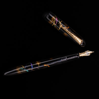 An overhead view of the Pilot Namiki Yukari Maki-e Fountain Pen - Firefly uncapped.