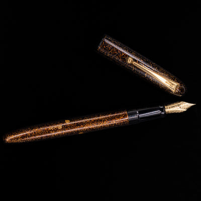 An overhead view of the Pilot Namiki Yukari Maki-e Fountain Pen - Sakura Fubuki uncapped. 