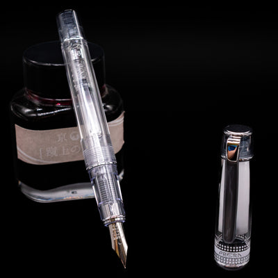 Pilot Prera Fountain Pen - Black leaning on an ink bottle uncapped showcasing the detailing on the nib.
