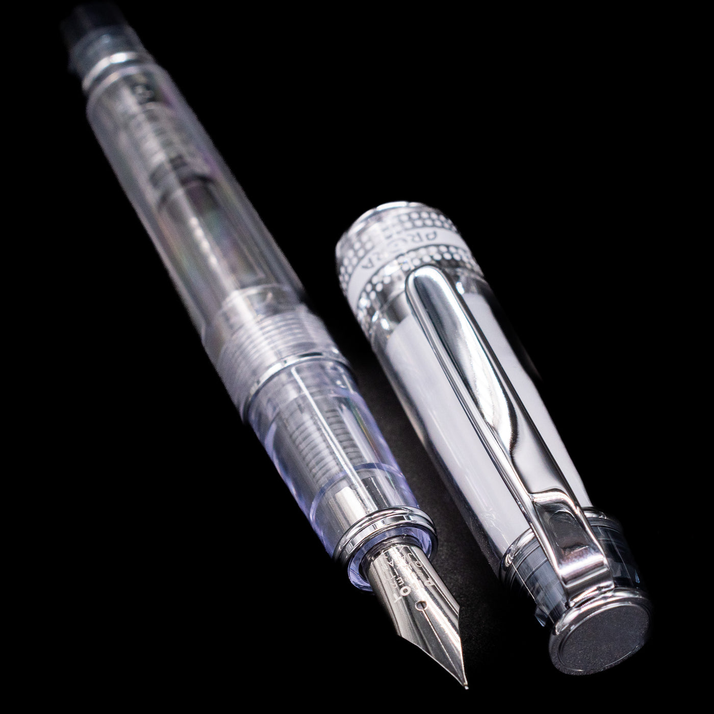 A full view of the Pilot Prera Fountain Pen - Black uncapped, with its cap laying next to the pen. 