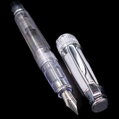 A full view of the Pilot Prera Fountain Pen - Black uncapped, with its cap laying next to the pen. 