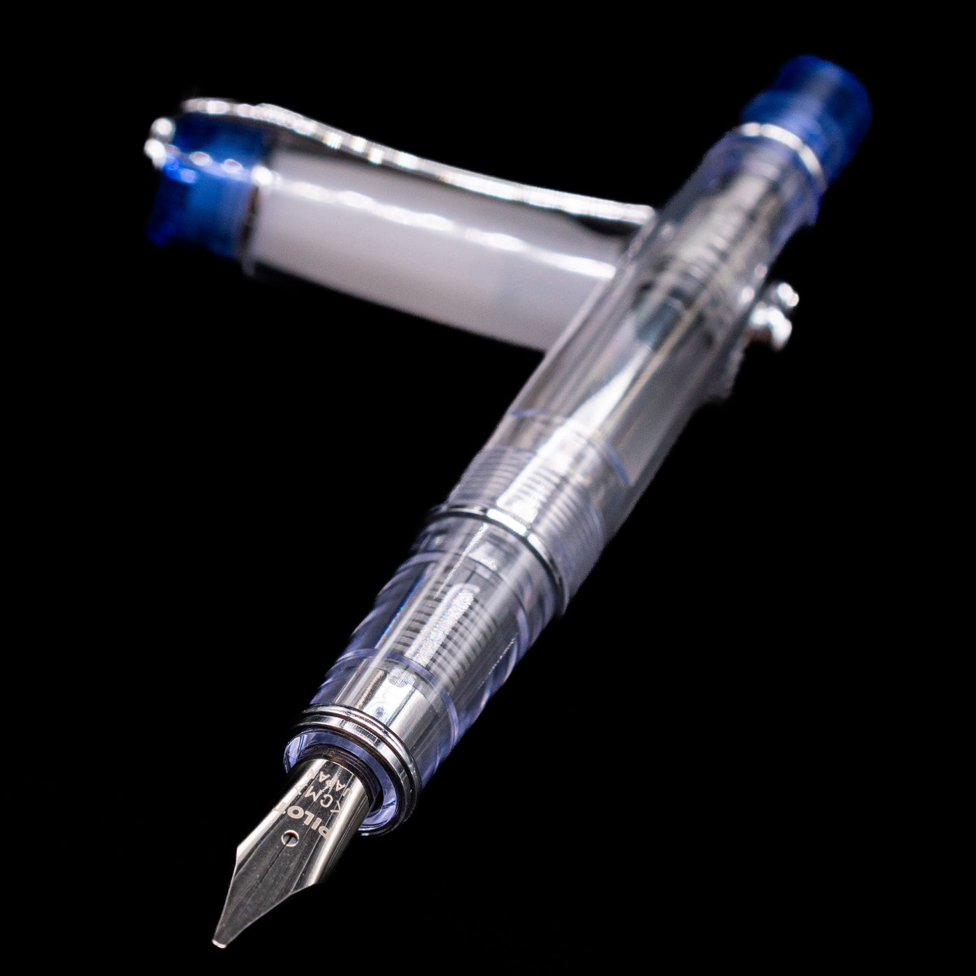 Pilot Prera Fountain Pen - Blue laying across its own cap, crossed, with a focus on the nib.