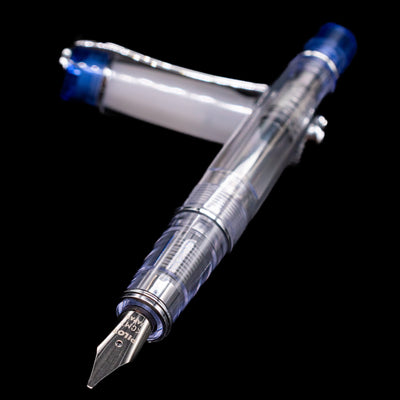 Pilot Prera Fountain Pen - Blue laying across its own cap, crossed, with a focus on the nib.