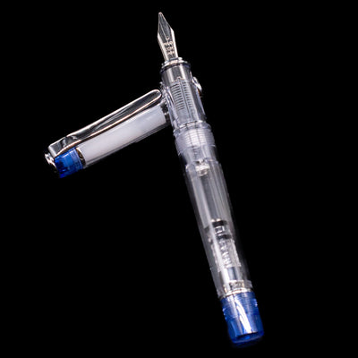 Pilot Prera Fountain Pen - Blue laying on top of its cap in a crossed position showing full view of the entire uncapped pen.