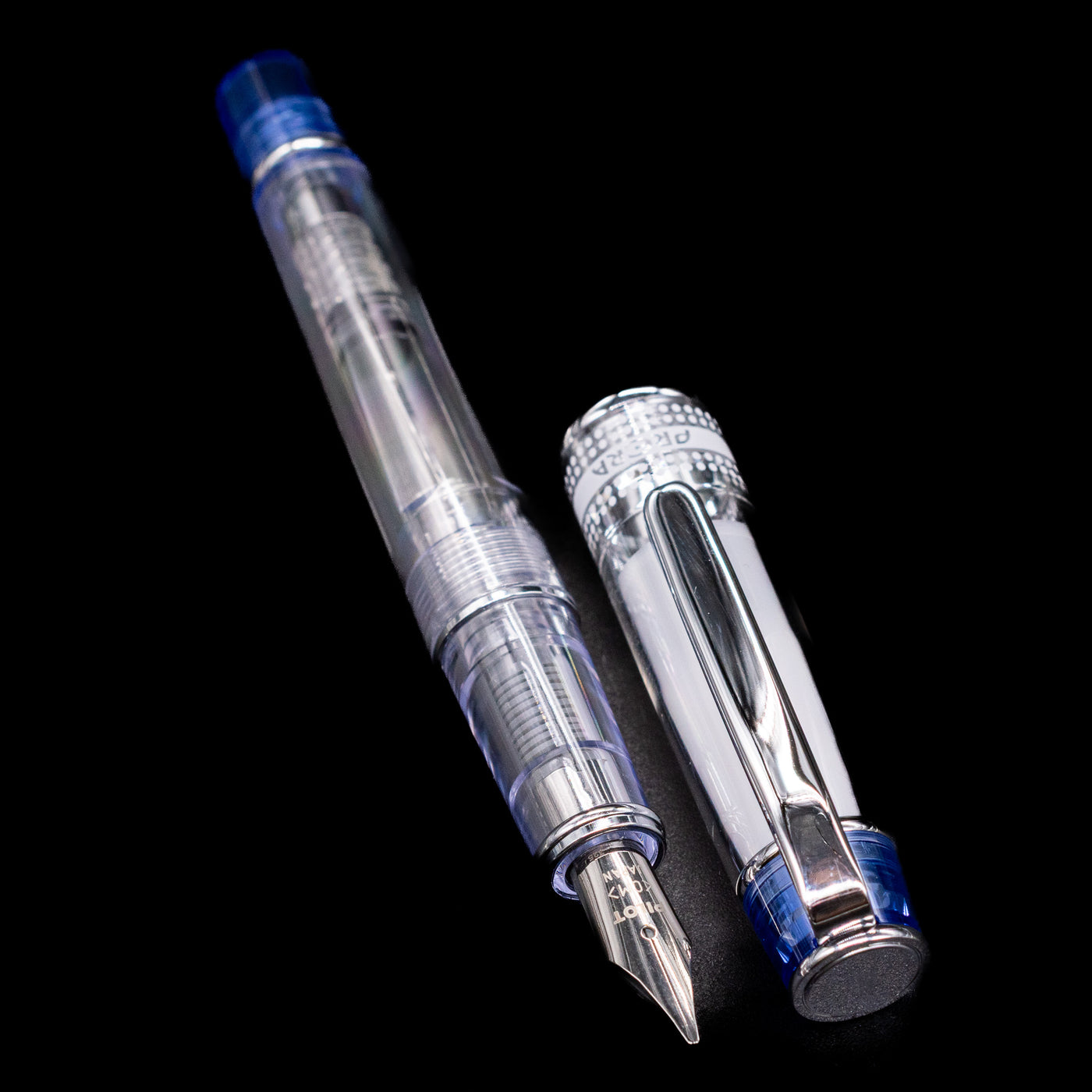 A full view of the Pilot Prera Fountain Pen - Blue uncapped, with its cap laying next to the pen. 