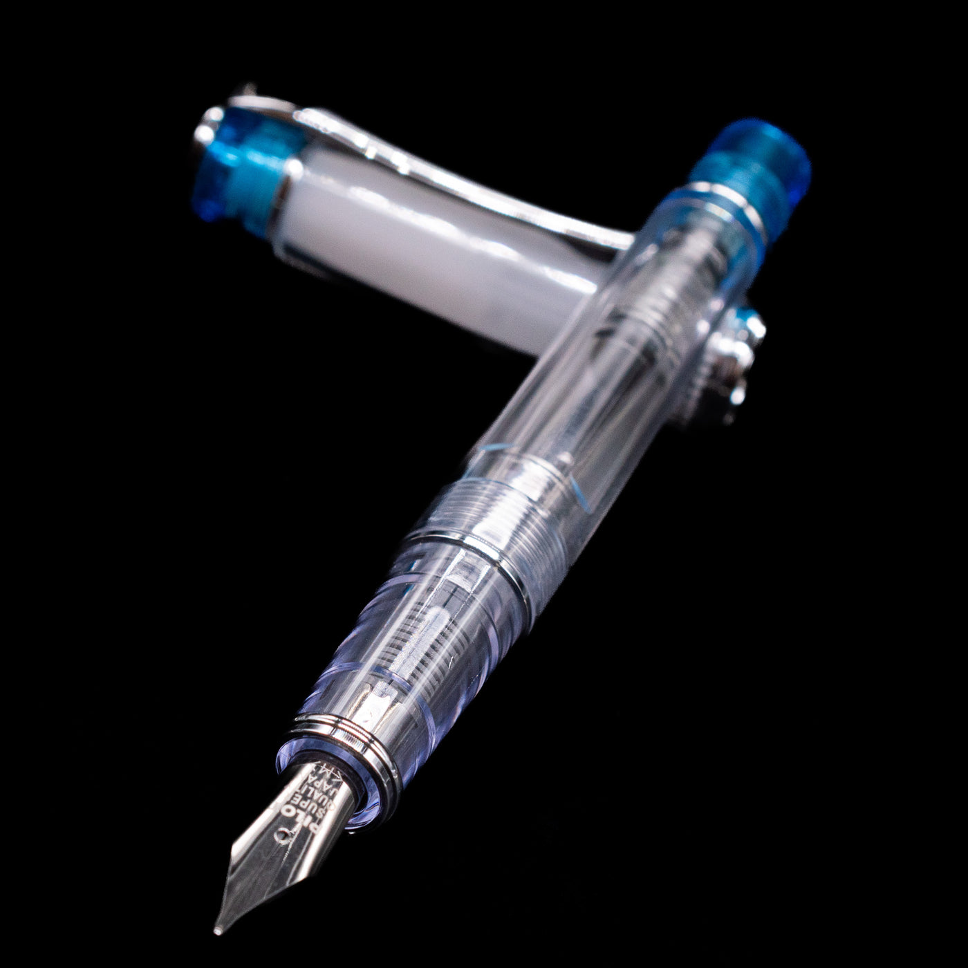 Pilot Prera Fountain Pen - Light Blue laying across its own cap, crossed, with a focus on the nib.