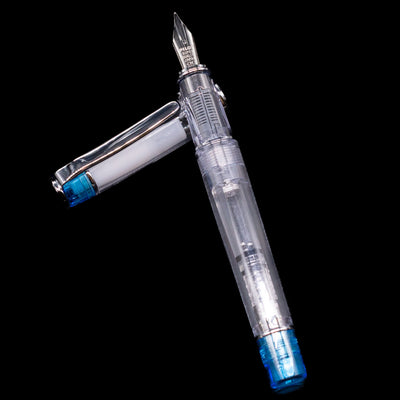 Pilot Prera Fountain Pen - Light Blue laying on top of its cap in a crossed position showing full view of the entire uncapped pen.