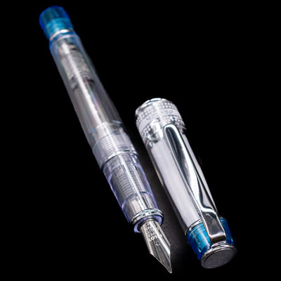 A full view of the Pilot Prera Fountain Pen - Light Blue uncapped, with its cap laying next to the pen. 