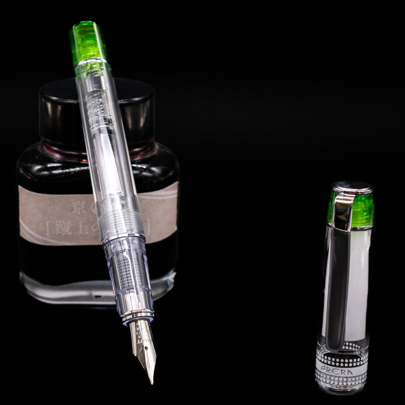 Pilot Prera Fountain Pen - Light Green leaning on an ink bottle uncapped showcasing the detailing on the nib.