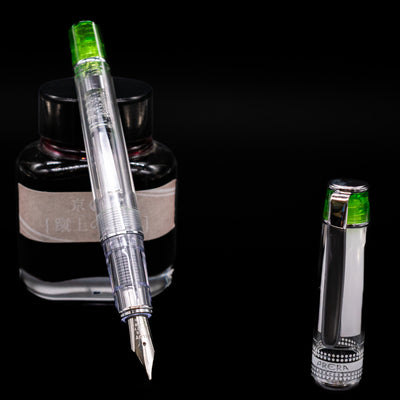 Pilot Prera Fountain Pen - Light Green leaning on an ink bottle uncapped showcasing the detailing on the nib.