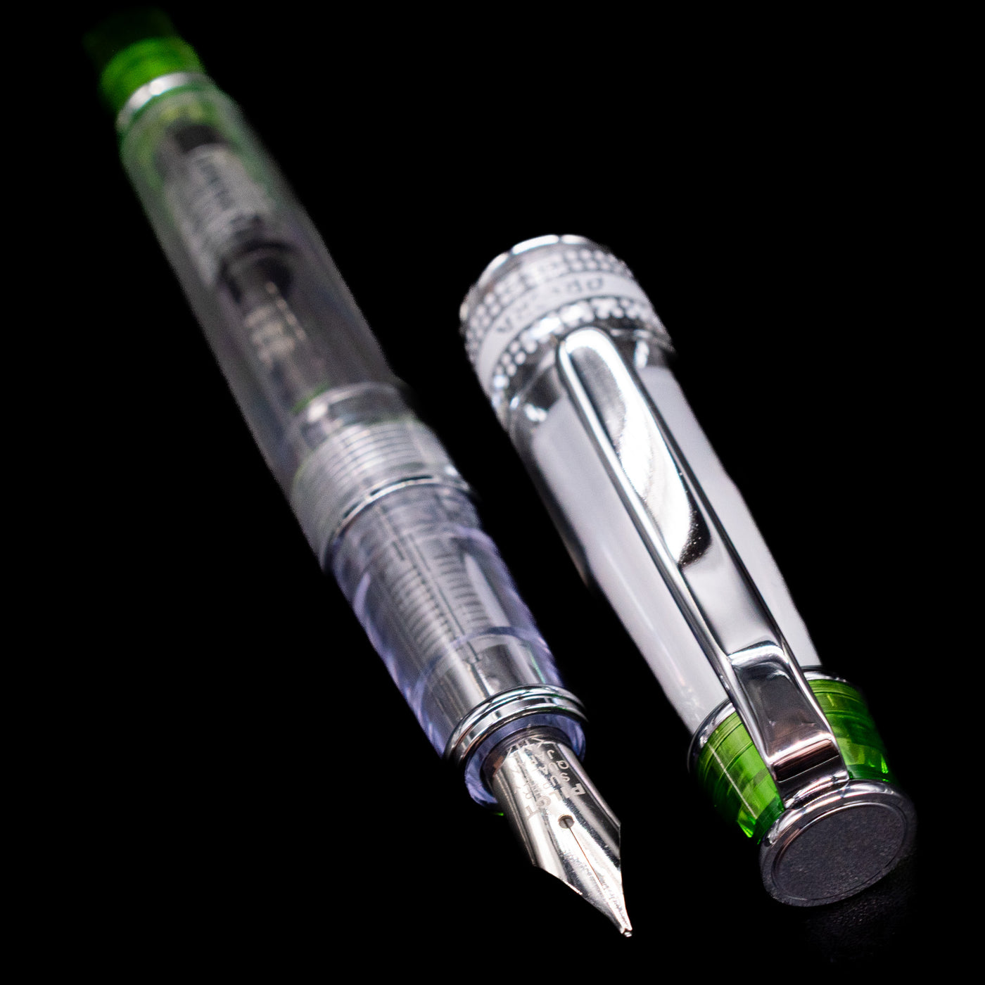 A full view of the Pilot Prera Fountain Pen - Light Green uncapped, with its cap laying next to the pen. 