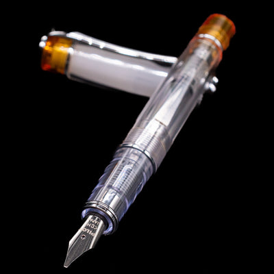 Pilot Prera Fountain Pen - Orange laying across its own cap, crossed, with a focus on the nib.