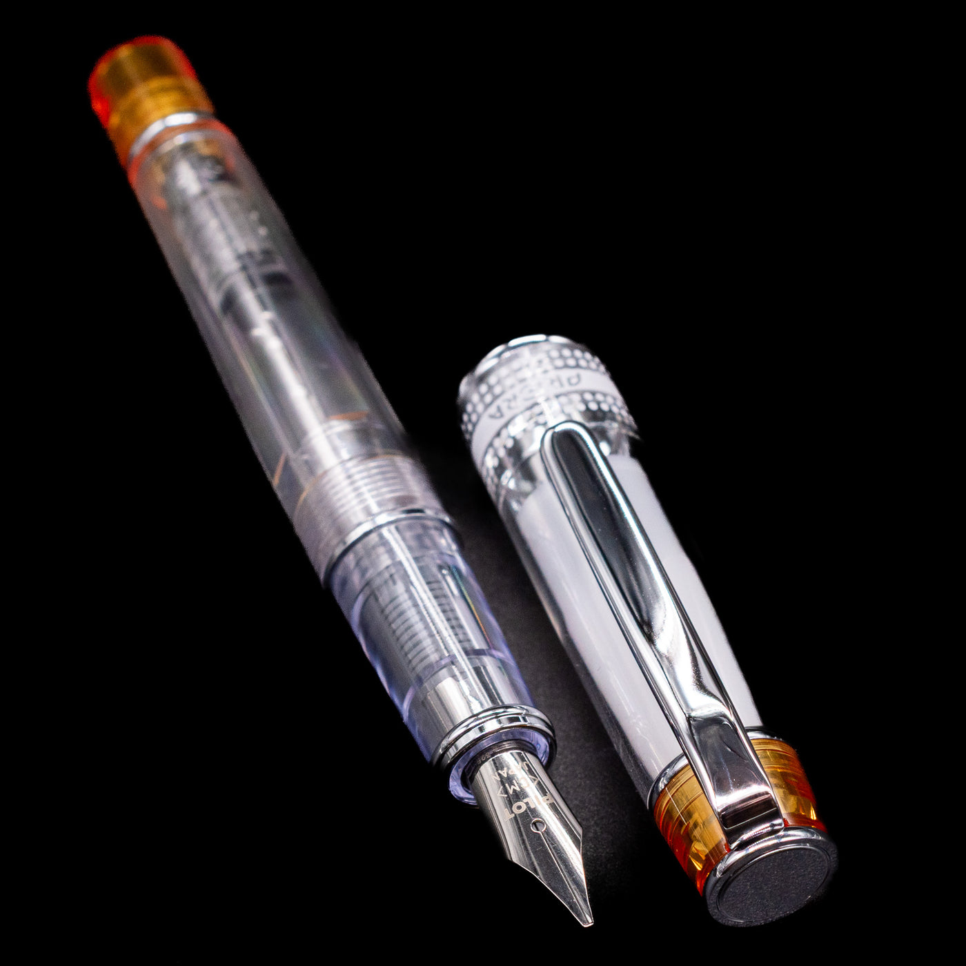  A full view of the Pilot Prera Fountain Pen - Orange uncapped, with its cap laying next to the pen. 