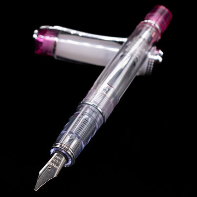 Pilot Prera Fountain Pen - Pink laying across its own cap, crossed, with a focus on the nib.