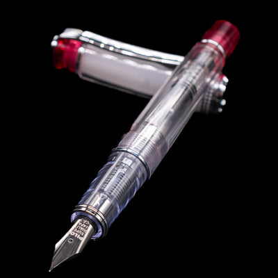 Pilot Prera Fountain Pen - Red laying across its own cap, crossed, with a focus on the nib.
