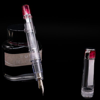 Pilot Prera Fountain Pen - Red leaning on an ink bottle uncapped showcasing the detailing on the nib.