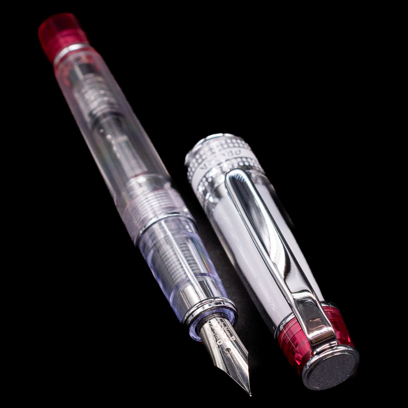 A full view of the Pilot Prera Fountain Pen - Red uncapped, with its cap laying next to the pen. 