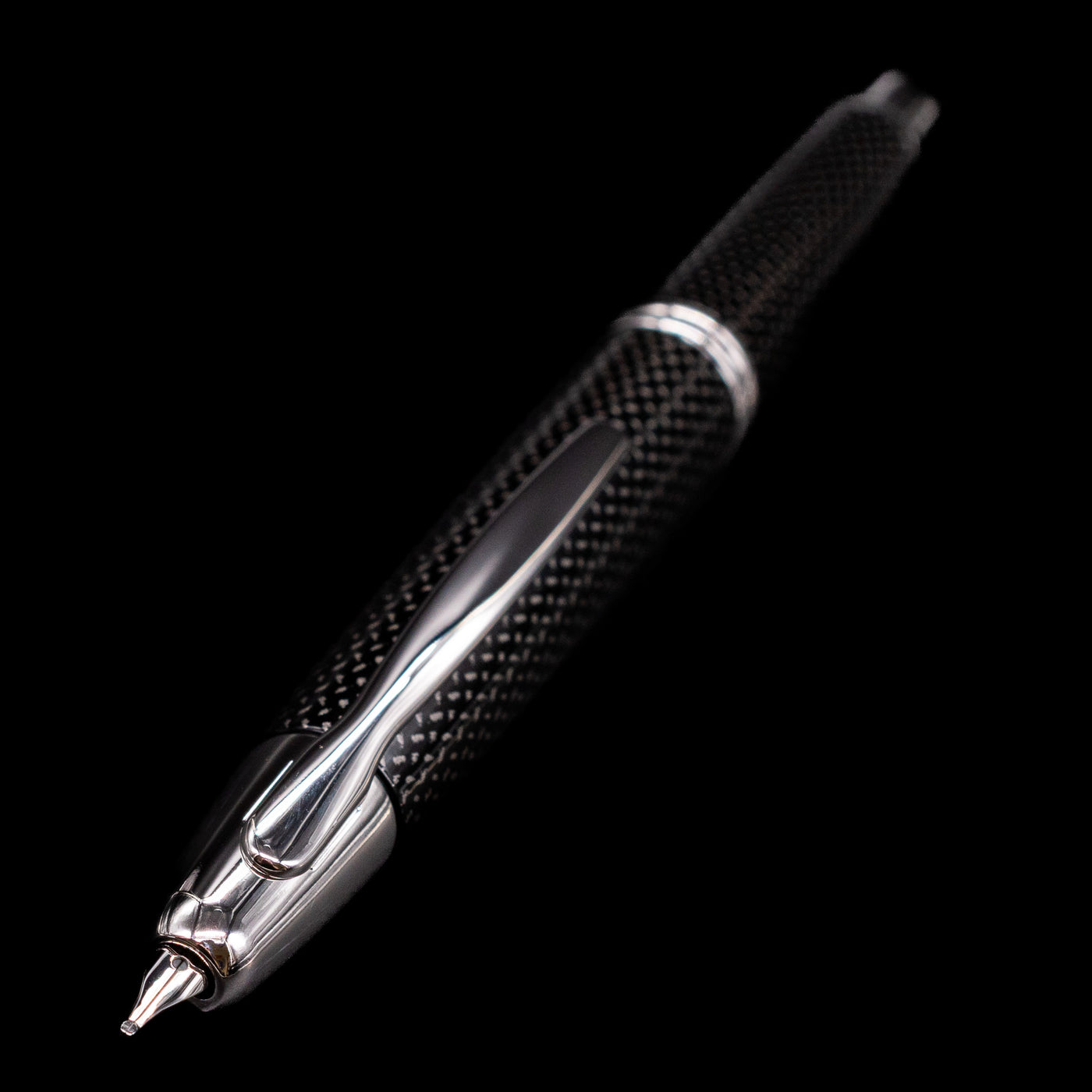 A full view of the Pilot Vanishing Point Fountain Pen - Black Carbonesque with a focus on the activated nib.