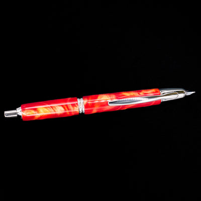 An overhead view of the Pilot Vanishing Point SE Fountain Pen - Marble Orange activated.