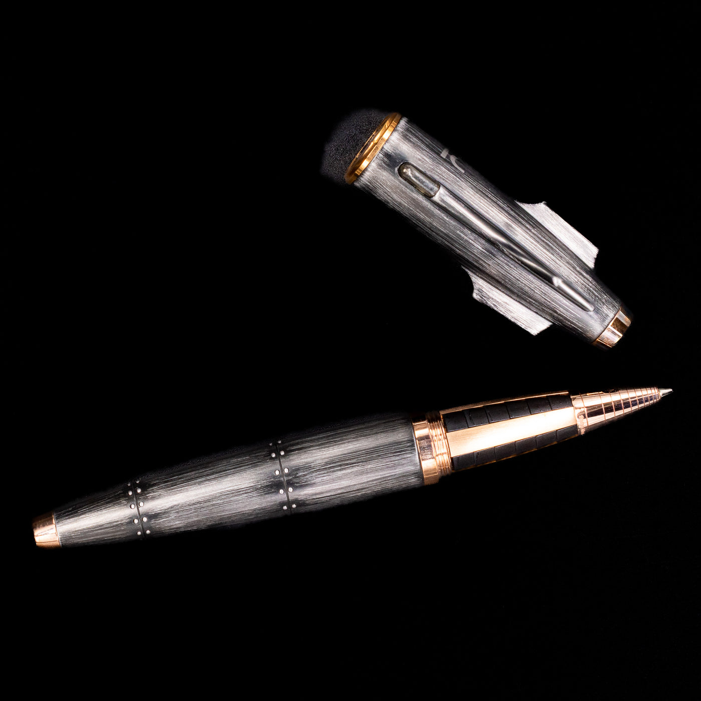 An overhead view of the Romain Jerome Moon Fighter Rollerball Pen - Vintage Finish uncapped.