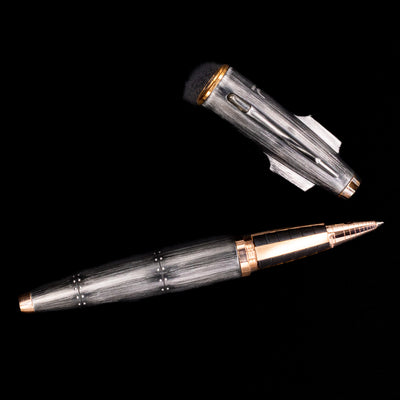 An overhead view of the Romain Jerome Moon Fighter Rollerball Pen - Vintage Finish uncapped.