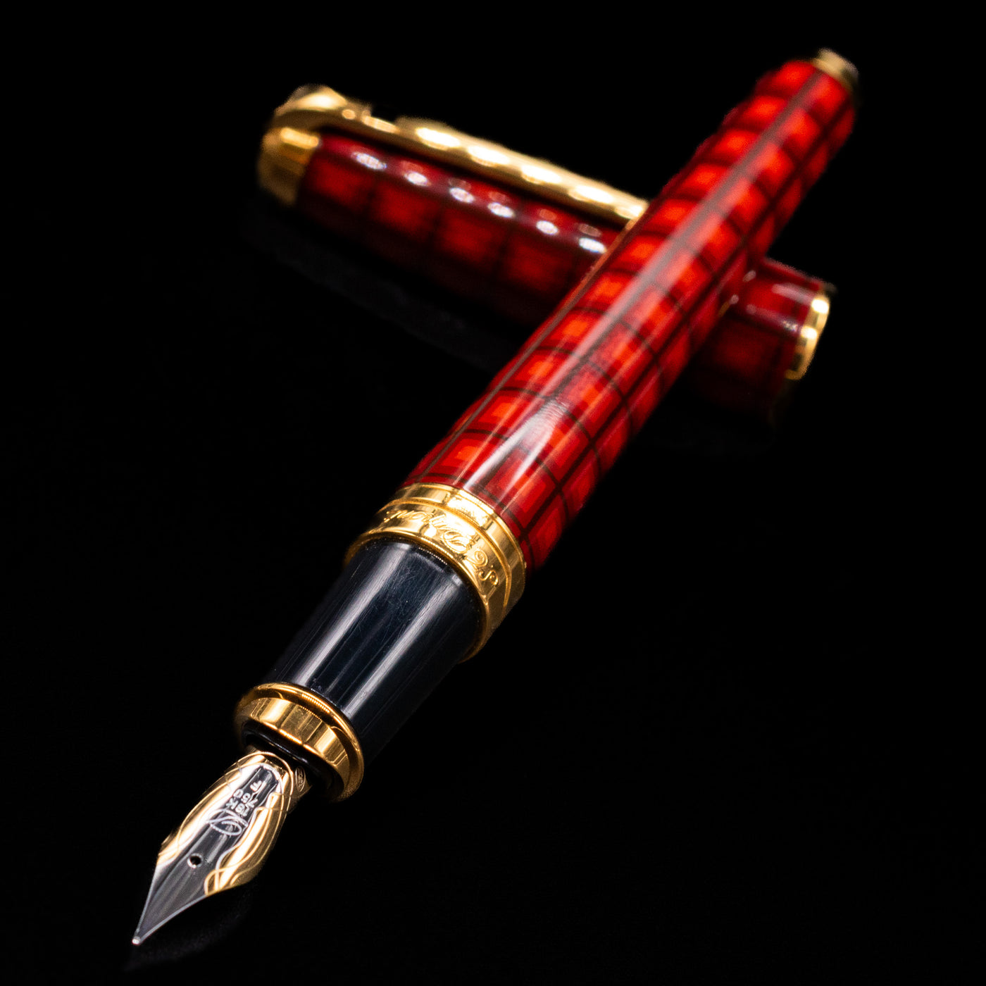 ST Dupont Olympio Vertigo Fountain Pen - Preowned laying across its own cap, crossed, with a focus on the nib.