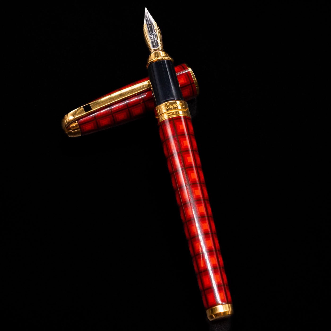 ST Dupont Olympio Vertigo Fountain Pen - Preowned laying on top of its cap in a crossed position showing full view of the entire uncapped pen.