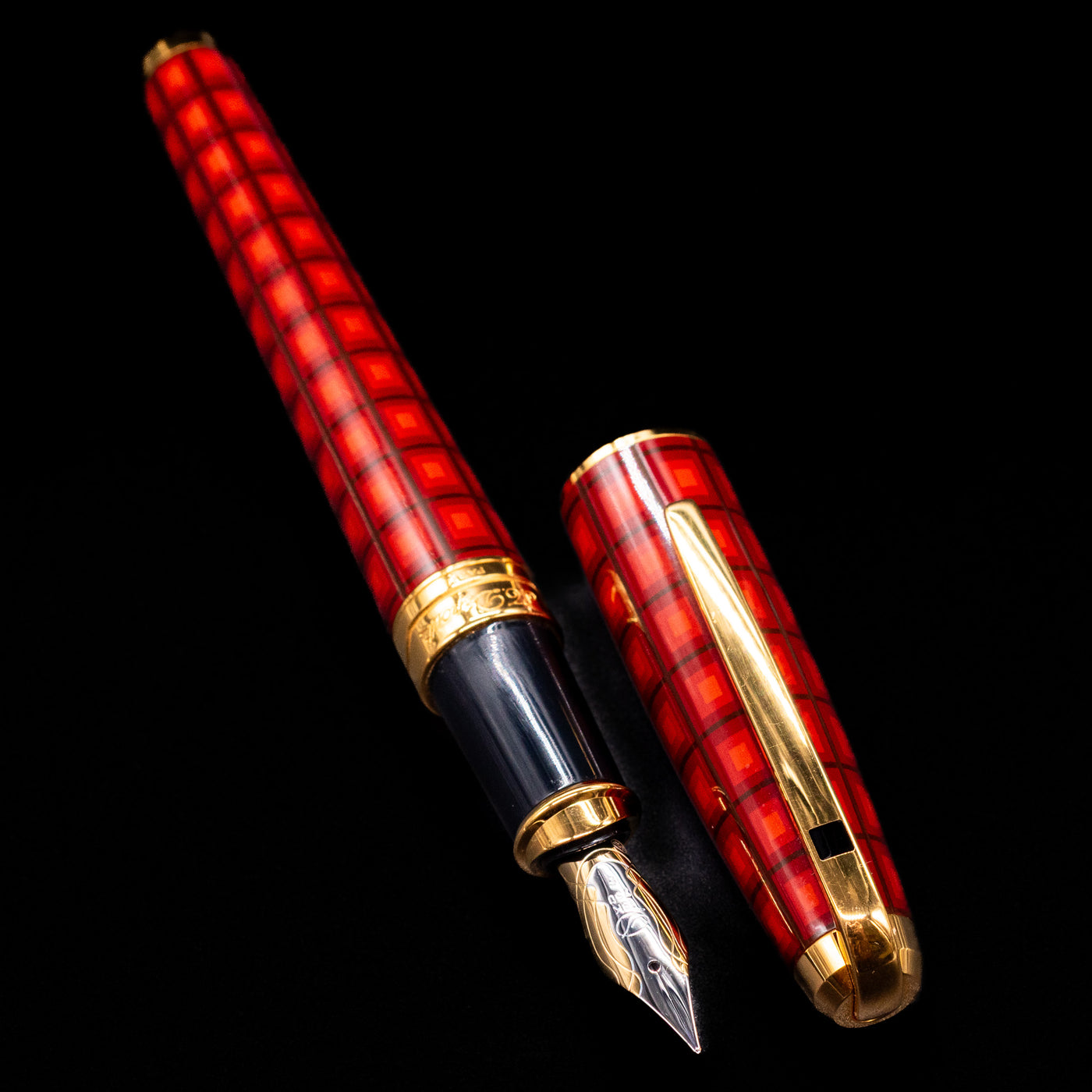 A full view of the ST Dupont Olympio Vertigo Fountain Pen - Preowned uncapped, with its cap laying next to the pen. 